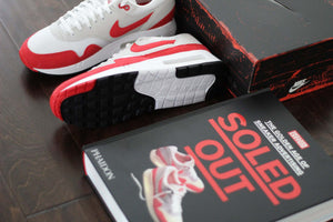 The Golden Age of Sneaker Advertising book with vintage Nike sneakers and box.